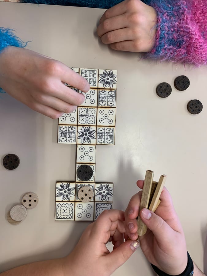 Mani, pedine e bastoncini durante una partita al Gioco reale di Ur